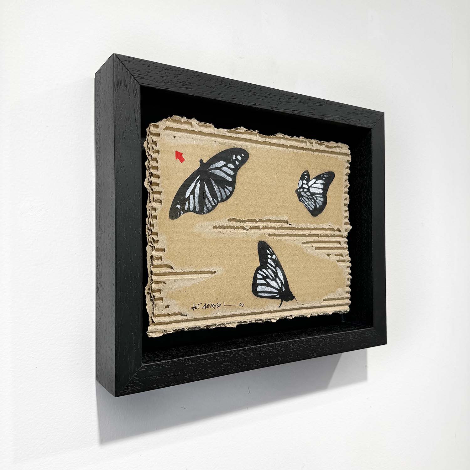 Tableau street art de Jef Aérosol représentant des papillons et la flèche rouge signature de l'artiste